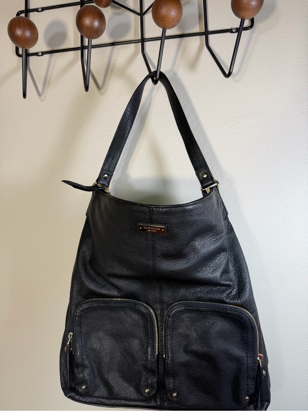 Kate Spade Black Leather tote bag with two front pockets.